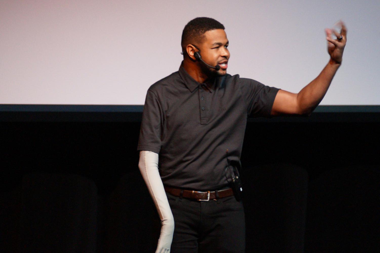 Inky Johnson wearing a black t-shirt with a black jeans during one of his speeches