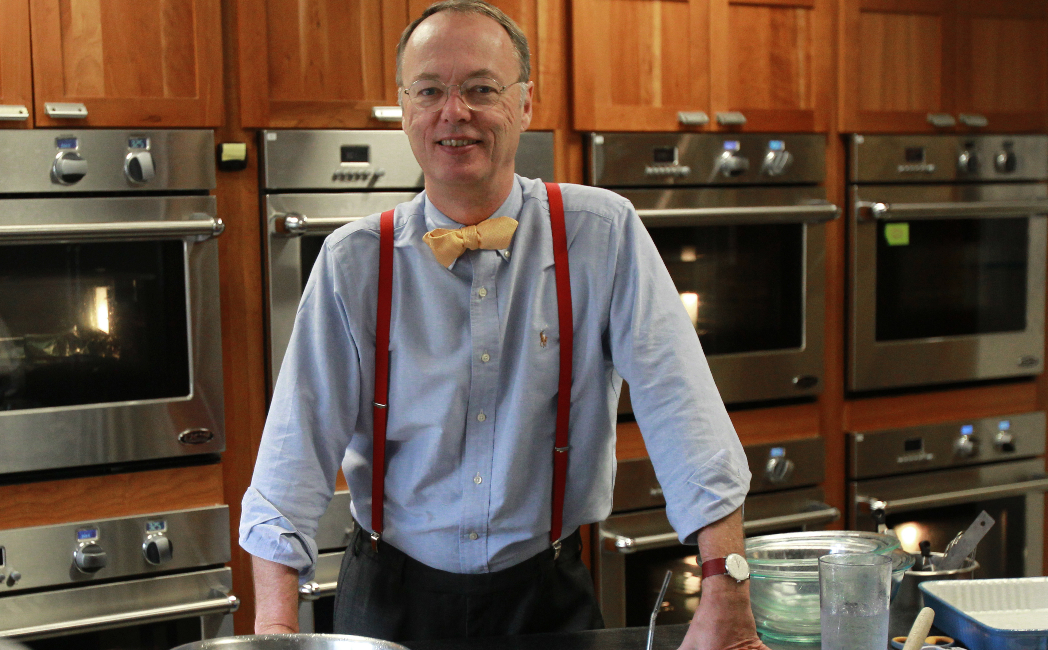 Christopher Kimball wearing a blue polo long sleeves and red extender