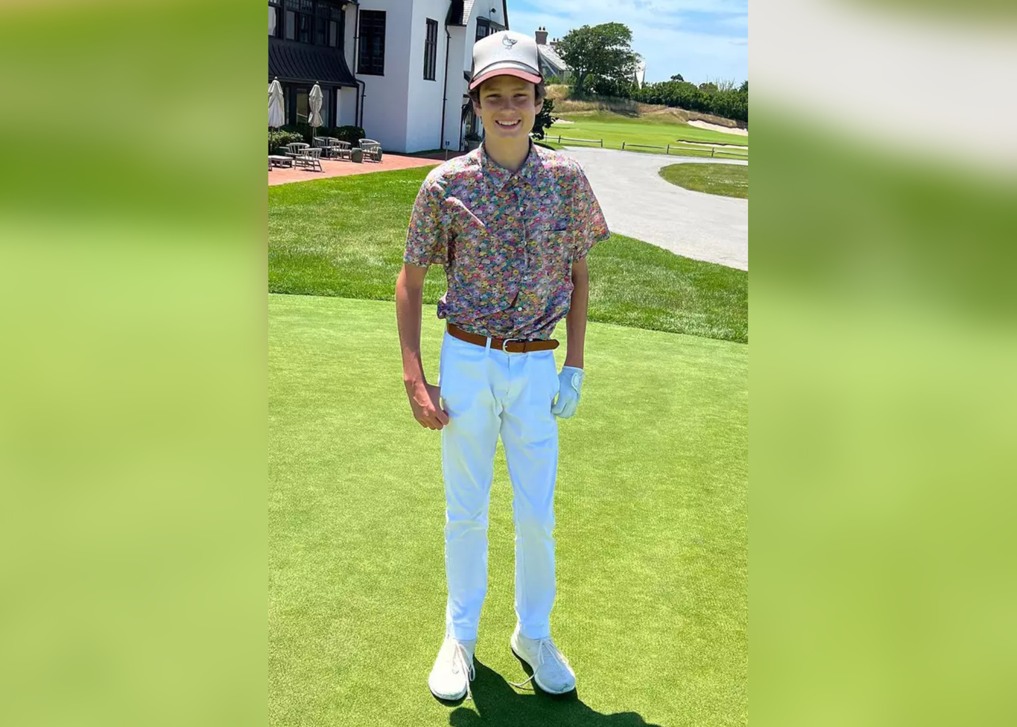 Jack Moynahan wears a floral polo shirt and white pants while standing in a green field