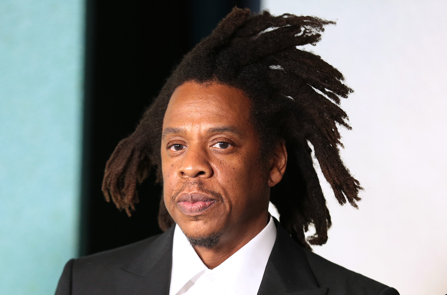 Jay-Z  wearing a black suit