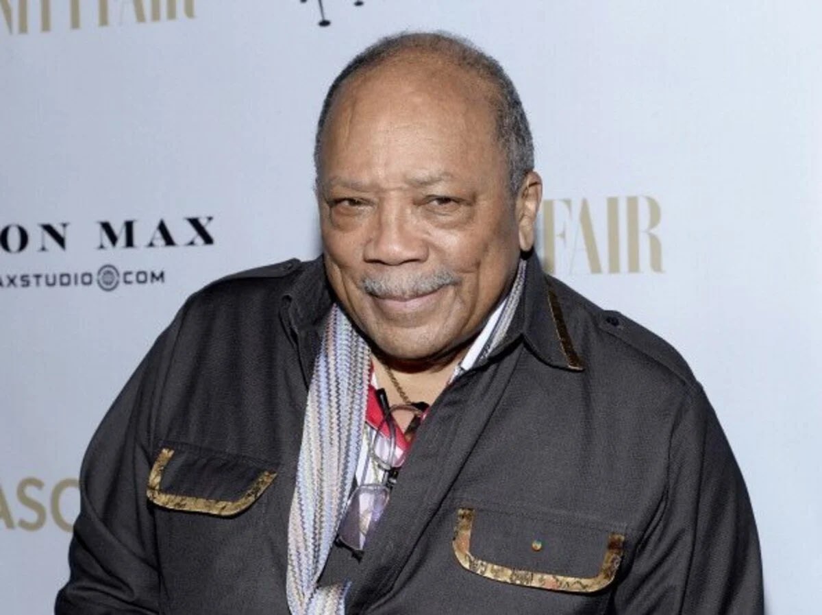Quincy Jones wearing a black jacket with accent pockets