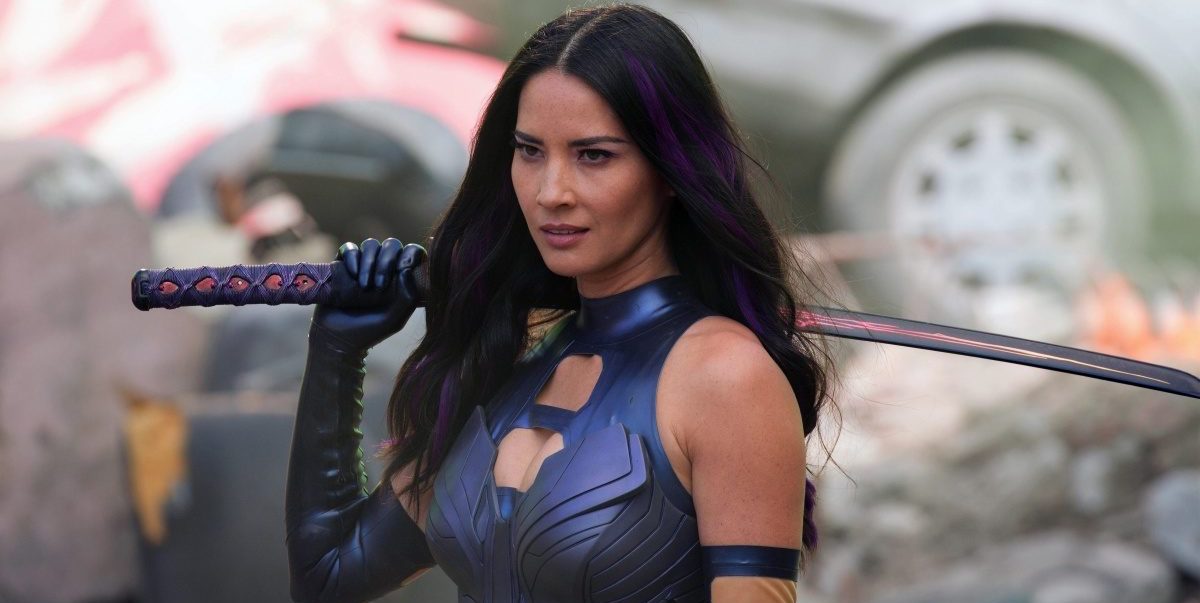Olivia Munn wearing a navy blue body suit while holding a katana