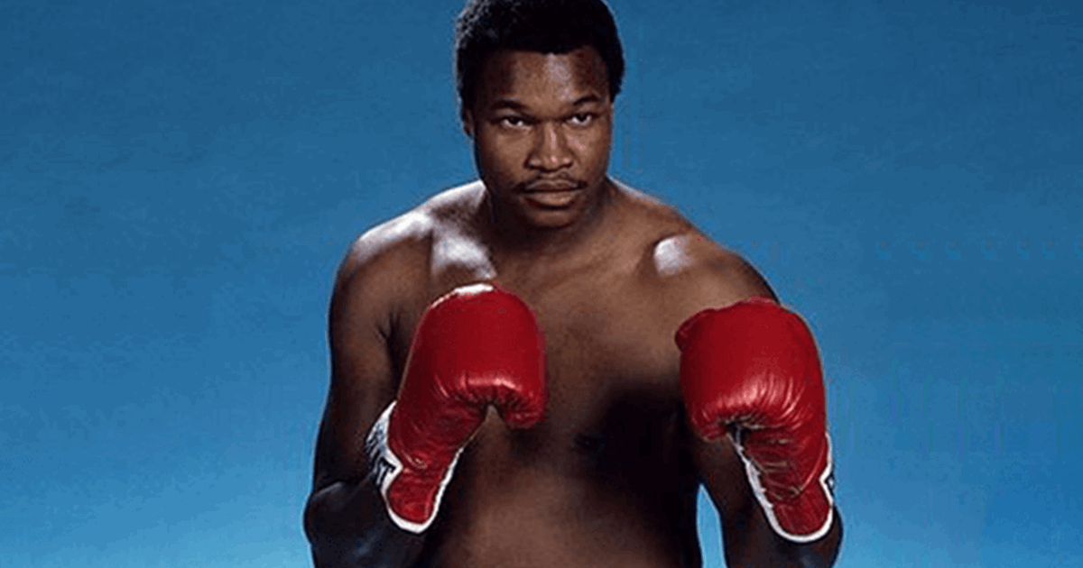 Larry Holmes topless while wearing a red boxing gloves