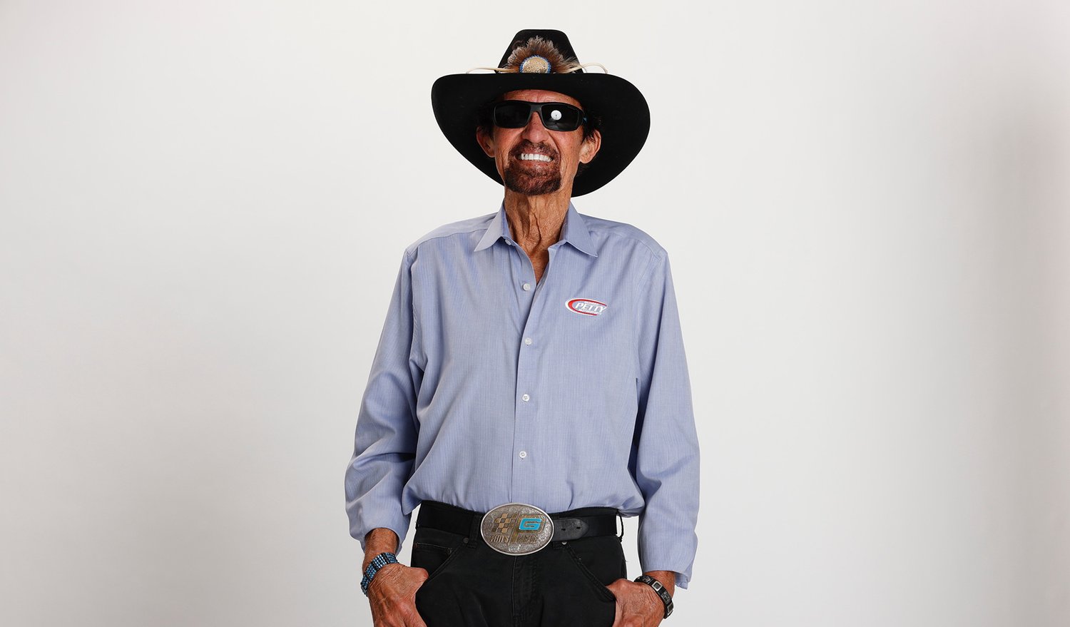 Richard Petty smiling and wearing cowboy hat and sunglasses