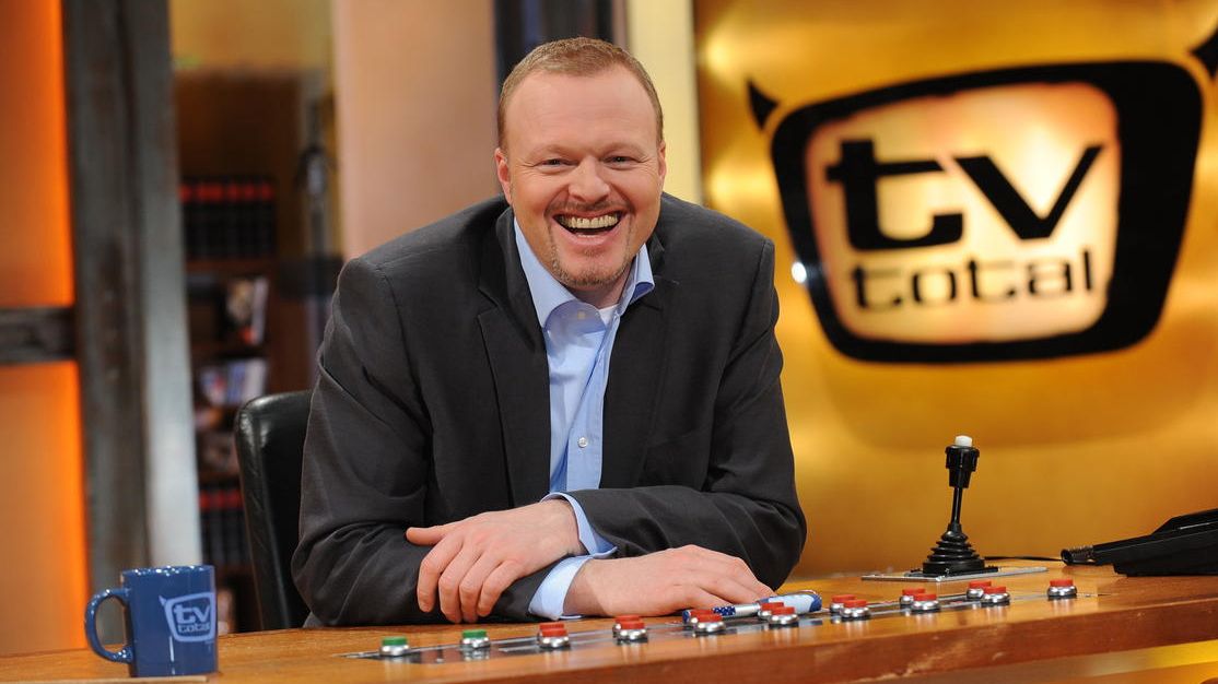 Stefan Raab wearing a black suit while laughing
