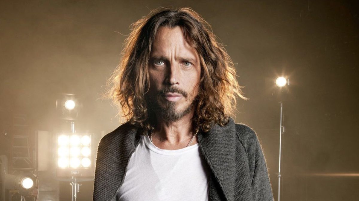 Chris Cornell wearing a whwite shirt and gray sweater