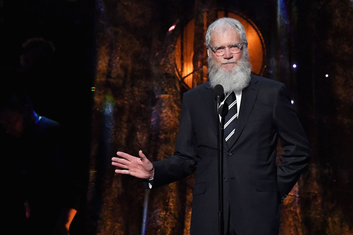 David Letterman wearing a black suit