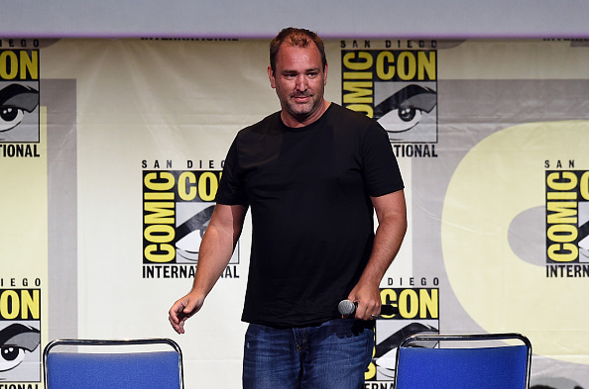 Trey Parker wearing a black shirt while holding a mic
