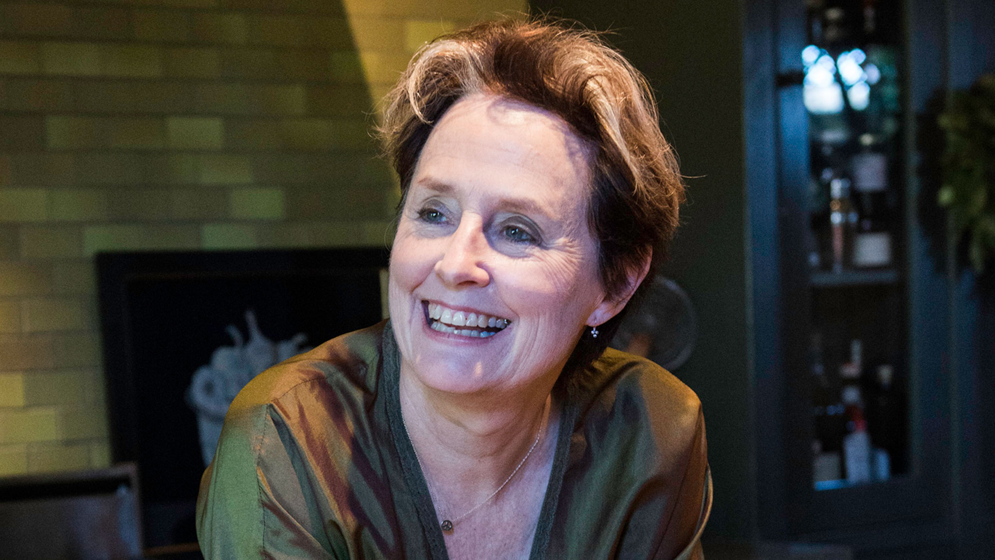 Smiling Alice Waters wearing a green outfit