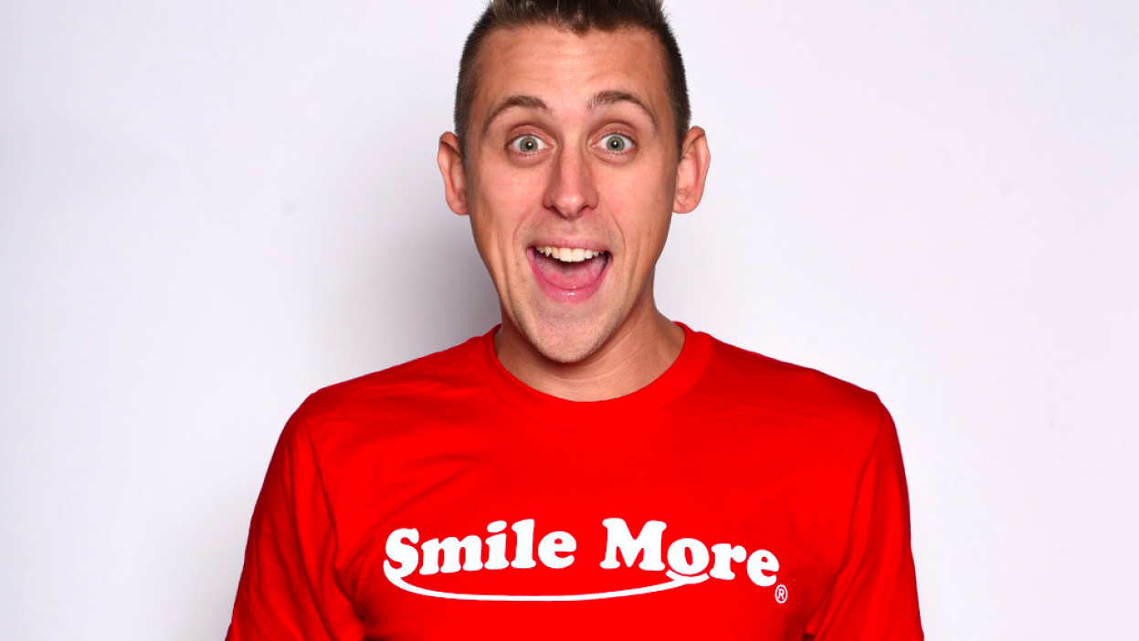Roman Atwood wearing a red shirt with print smile more