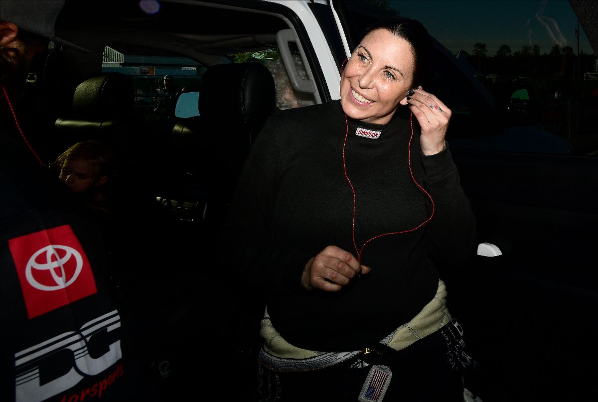 Alexis DeJoria wearing black long sleeves while putting earphones