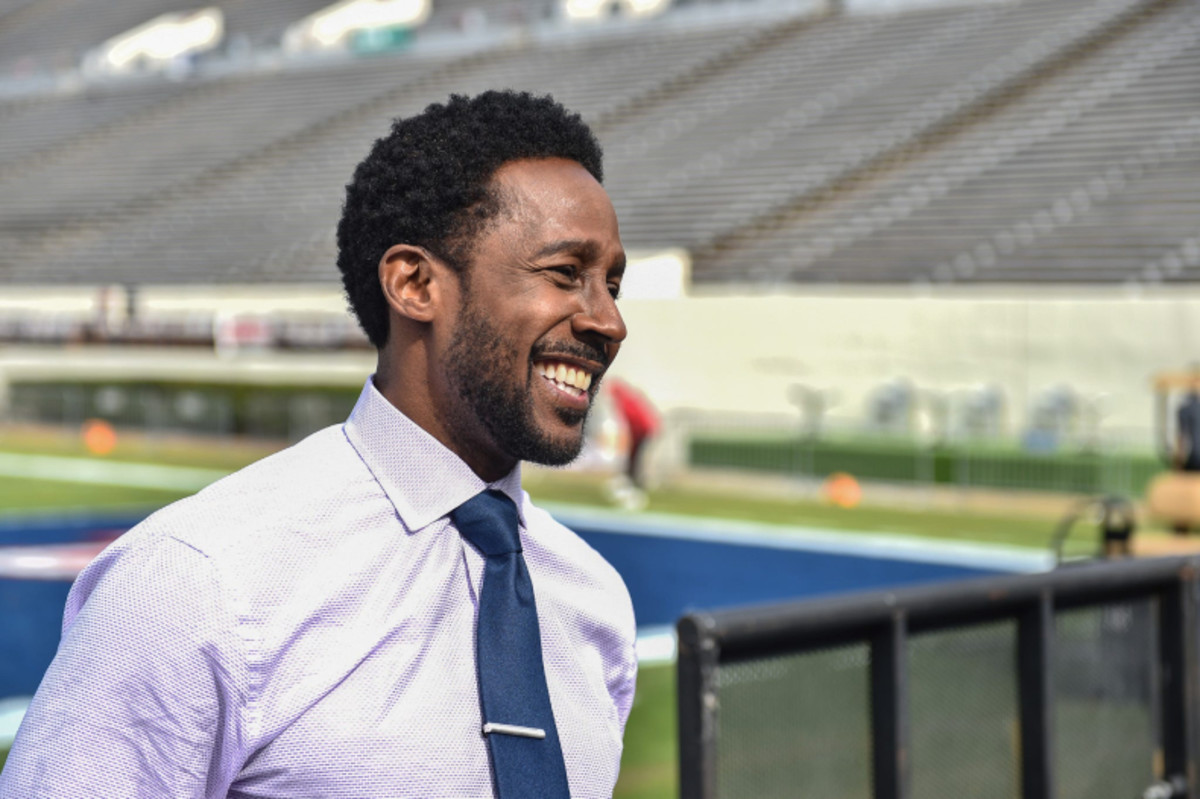 Desmond Howard wearing a polo long sleeves and blue neck tie