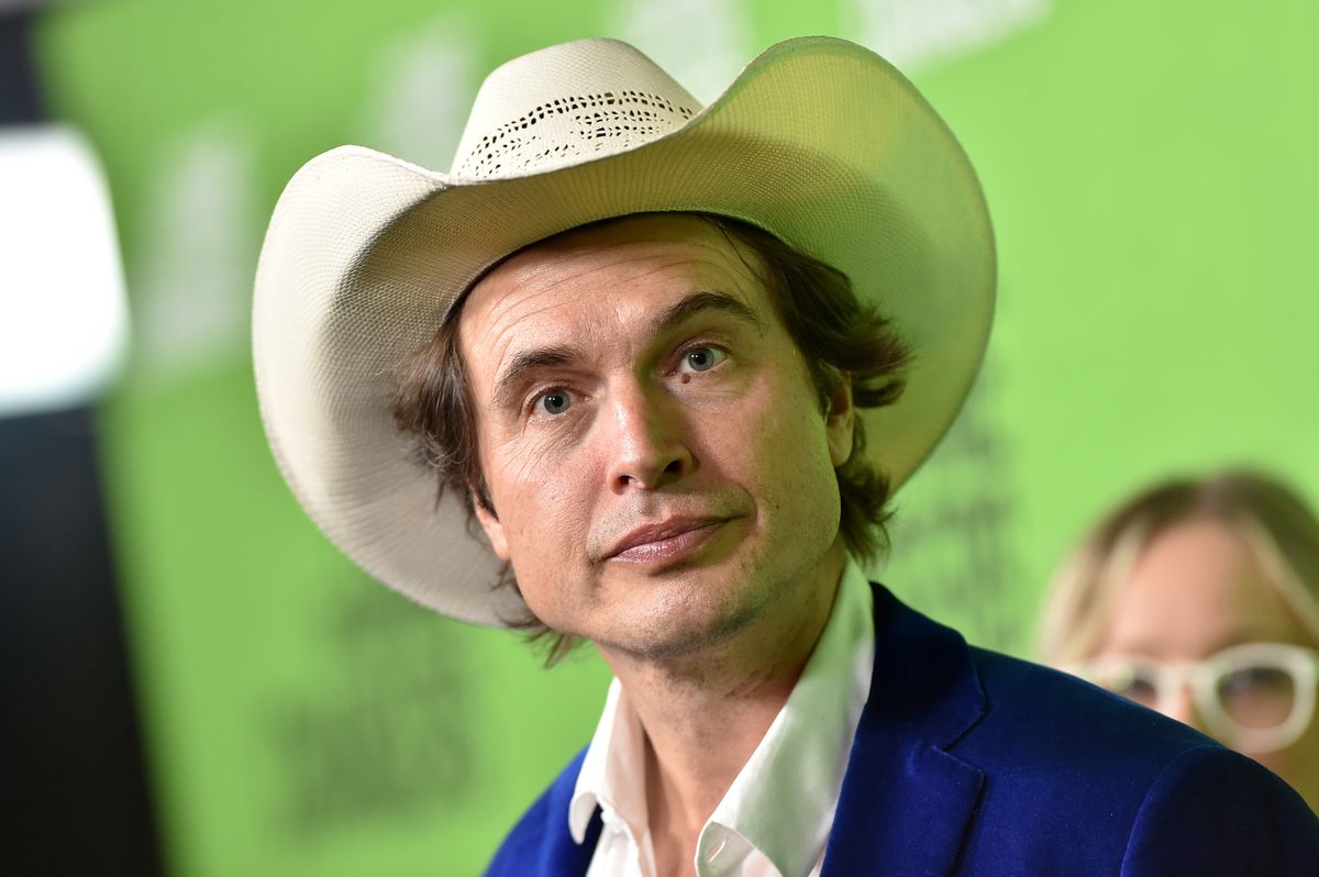Kimbal Musk wearing a blue suit and white cowboy hat