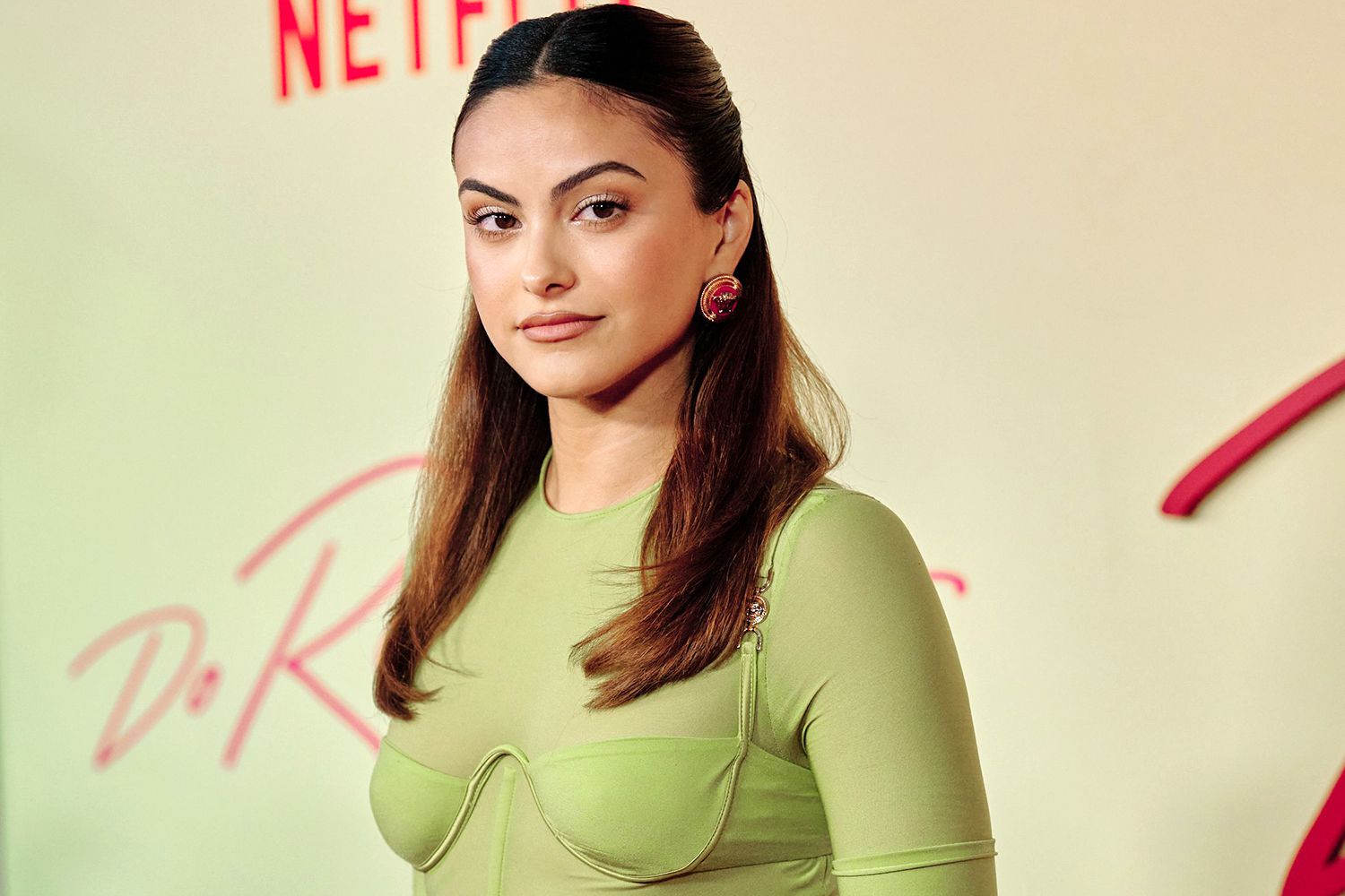Camila Mendes wearing a green outfit