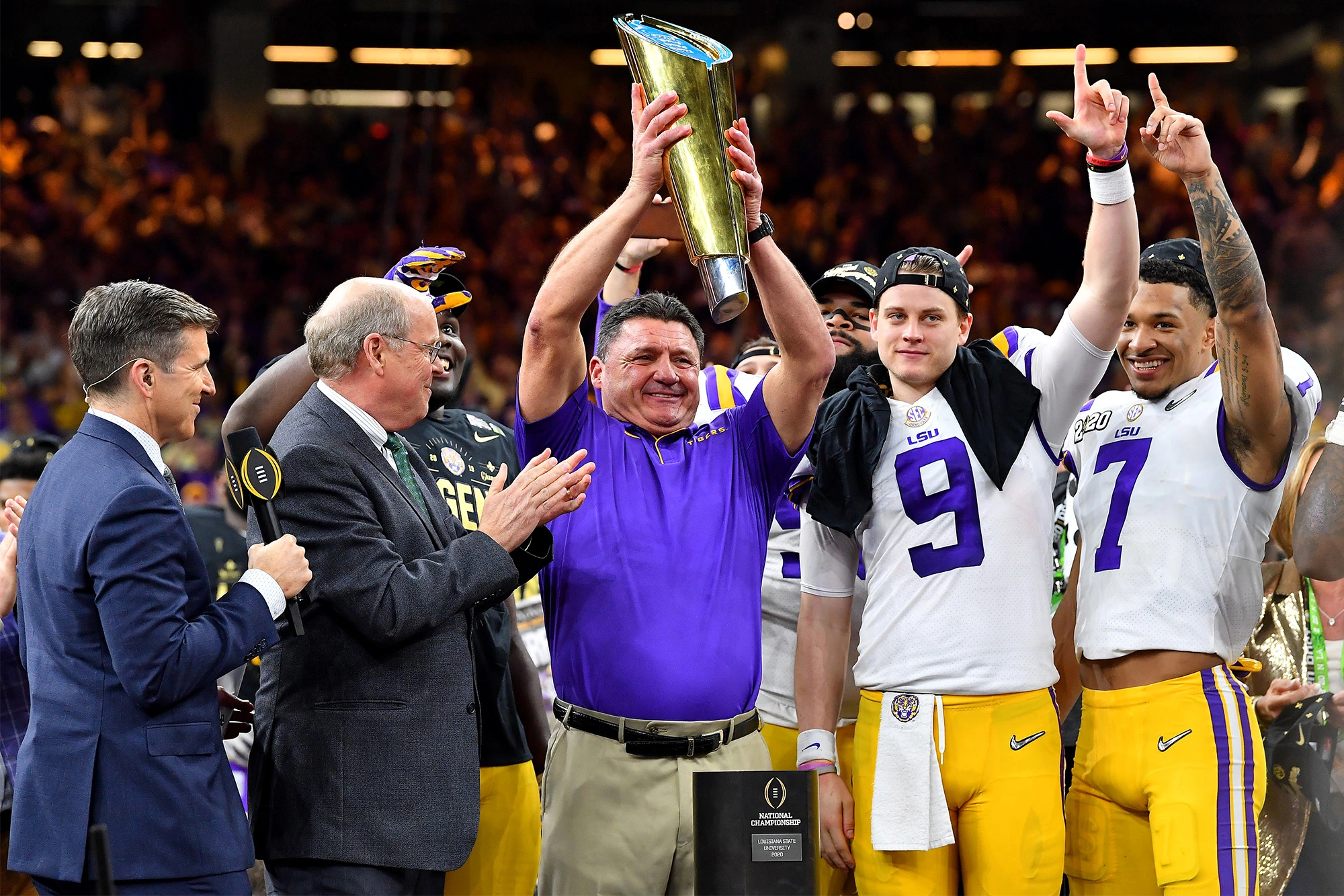 Ed Orgeron Holding Trophy