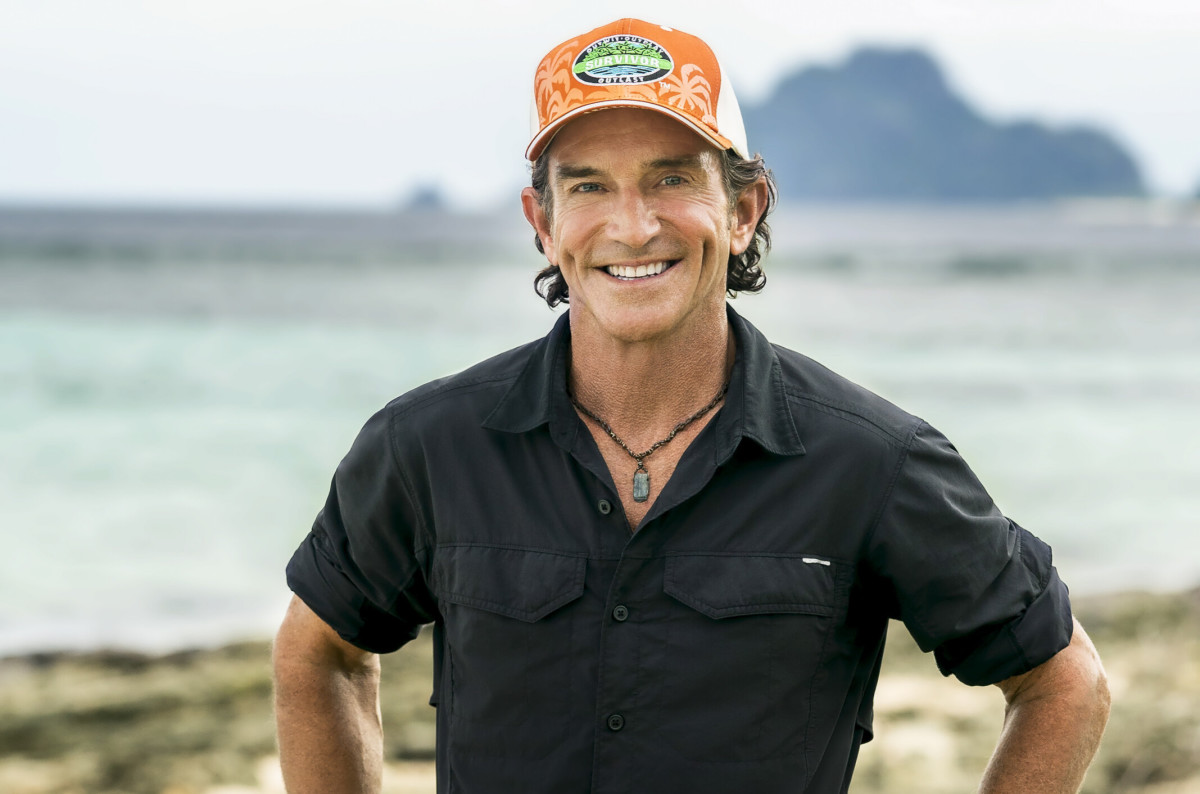 Jeff Probst wearing a black polo and orange cap