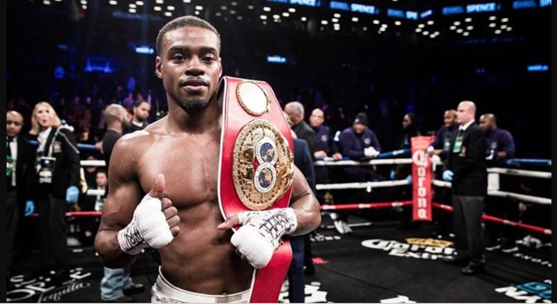 Errol Spence Jr. posing with his belt while giving a thumbs up after a fight