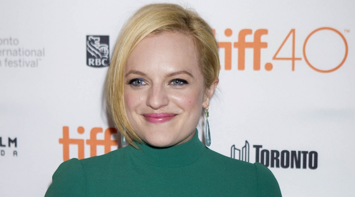 Elisabeth Moss wearing a green turtle neck outfit