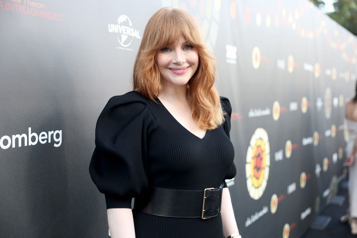Bryce Dallas Howard wearing a black gown at an event with a smile on her face