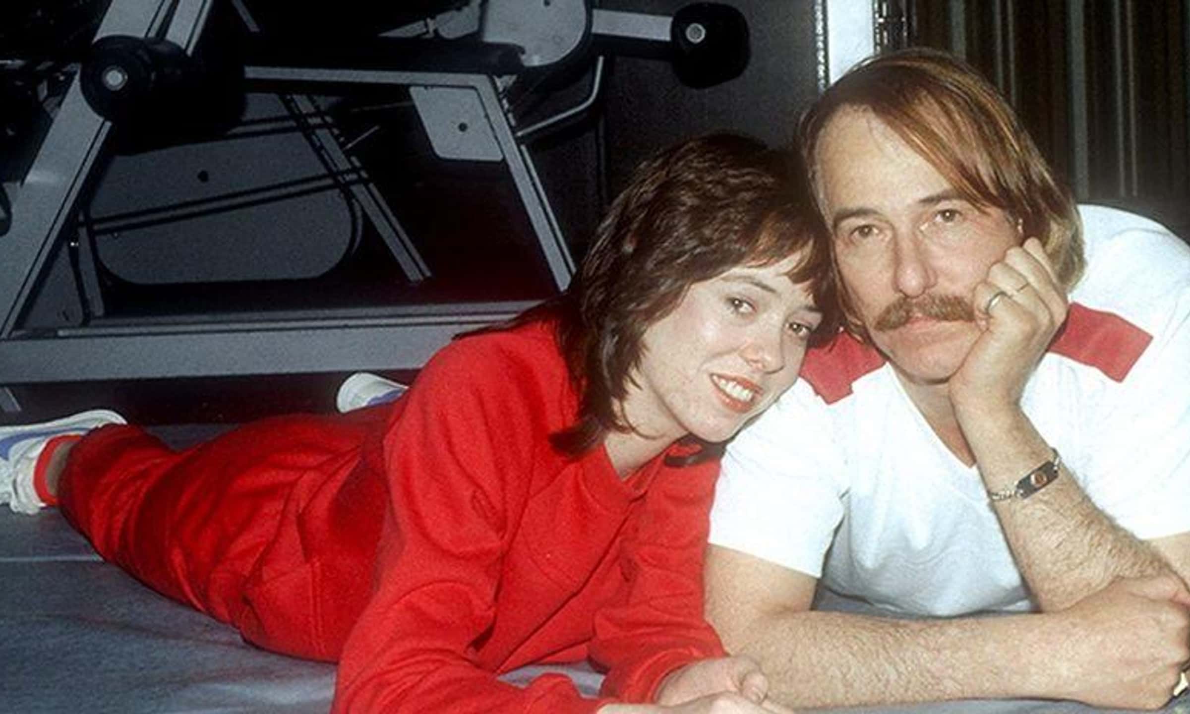 Mackenzie Phillips with her dad laying on the floor of a gym