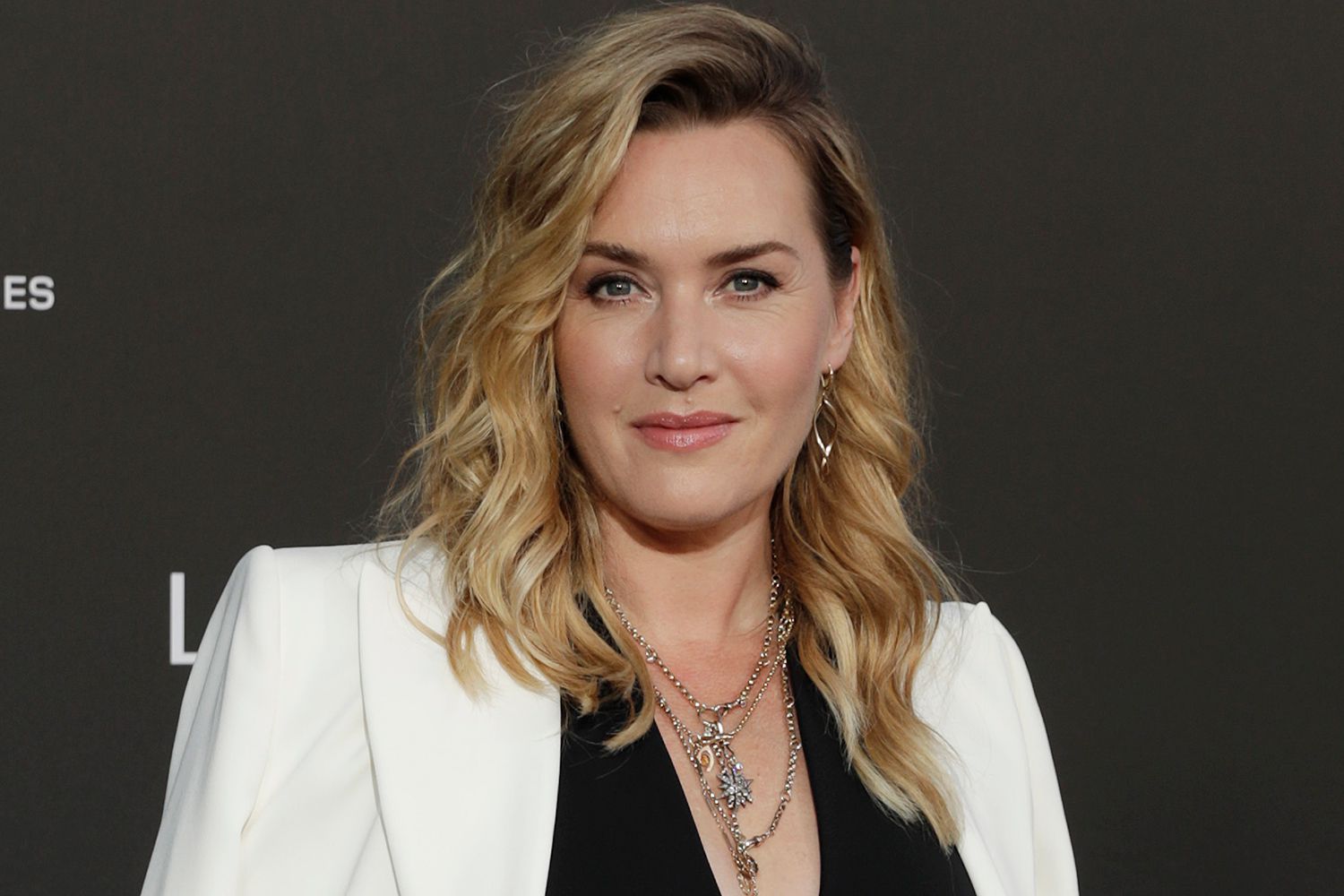 Kate Winslet wearing a white coat