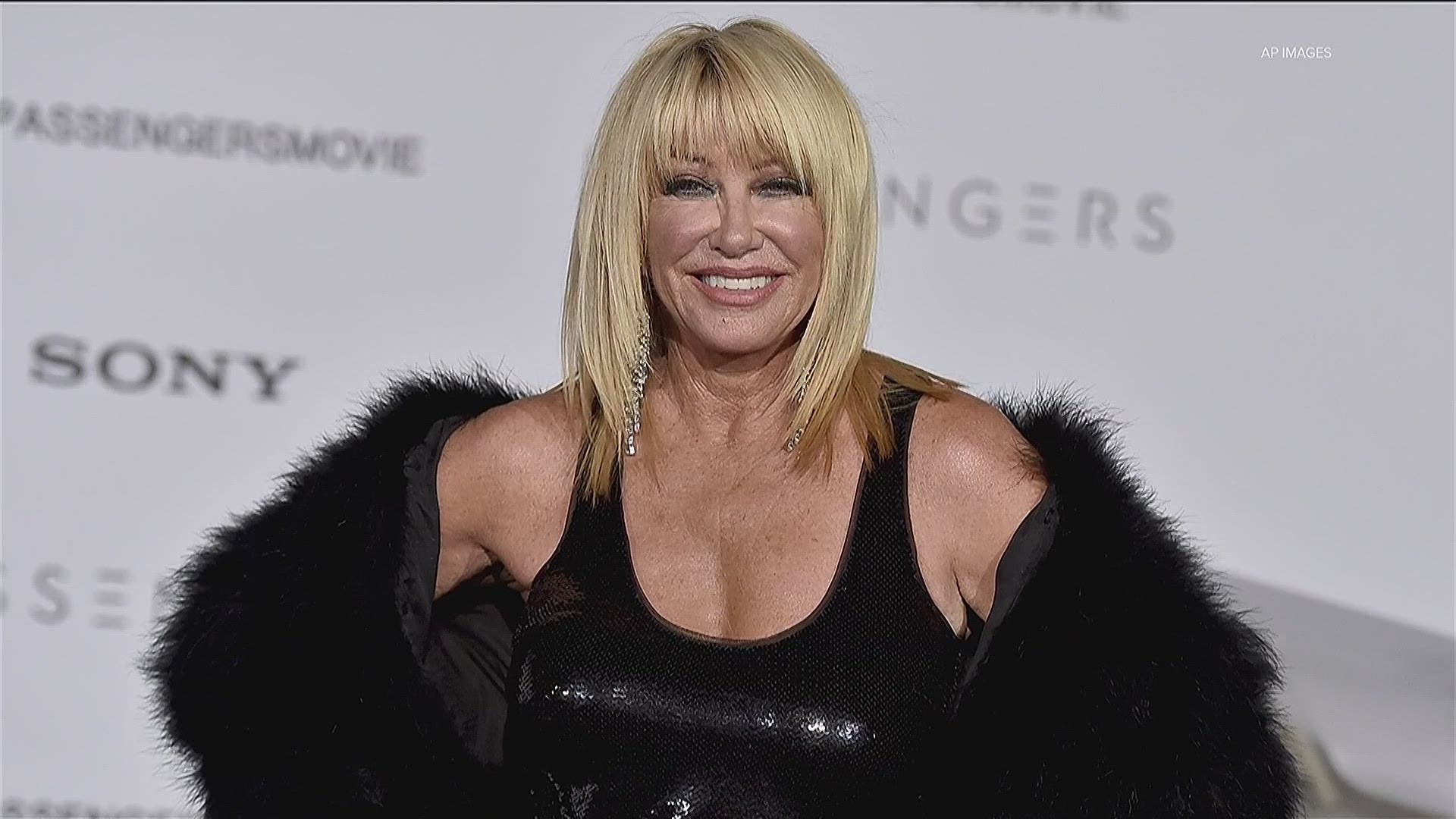 Suzanne Somers wearing a black top and black fur coat