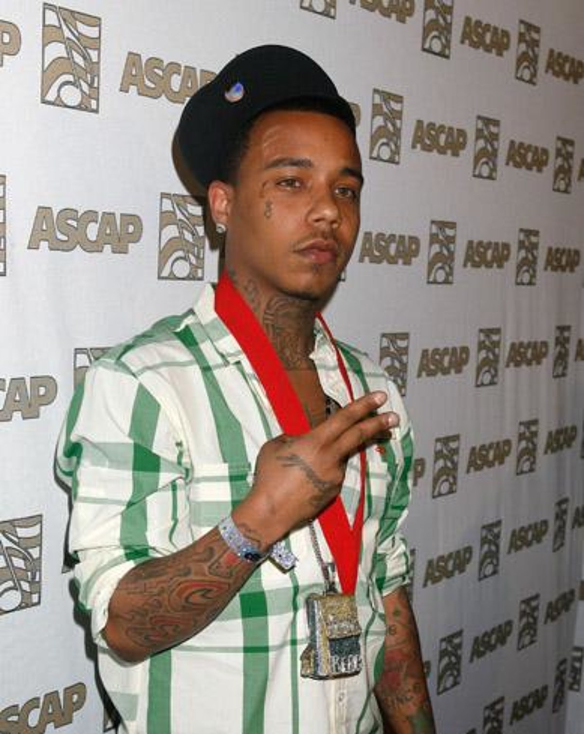 Yung Berg wearing a white shirt with green stripes