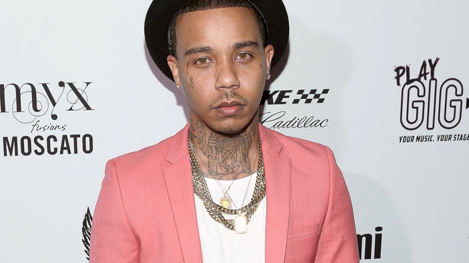 Yung Berg wearing a pink suit