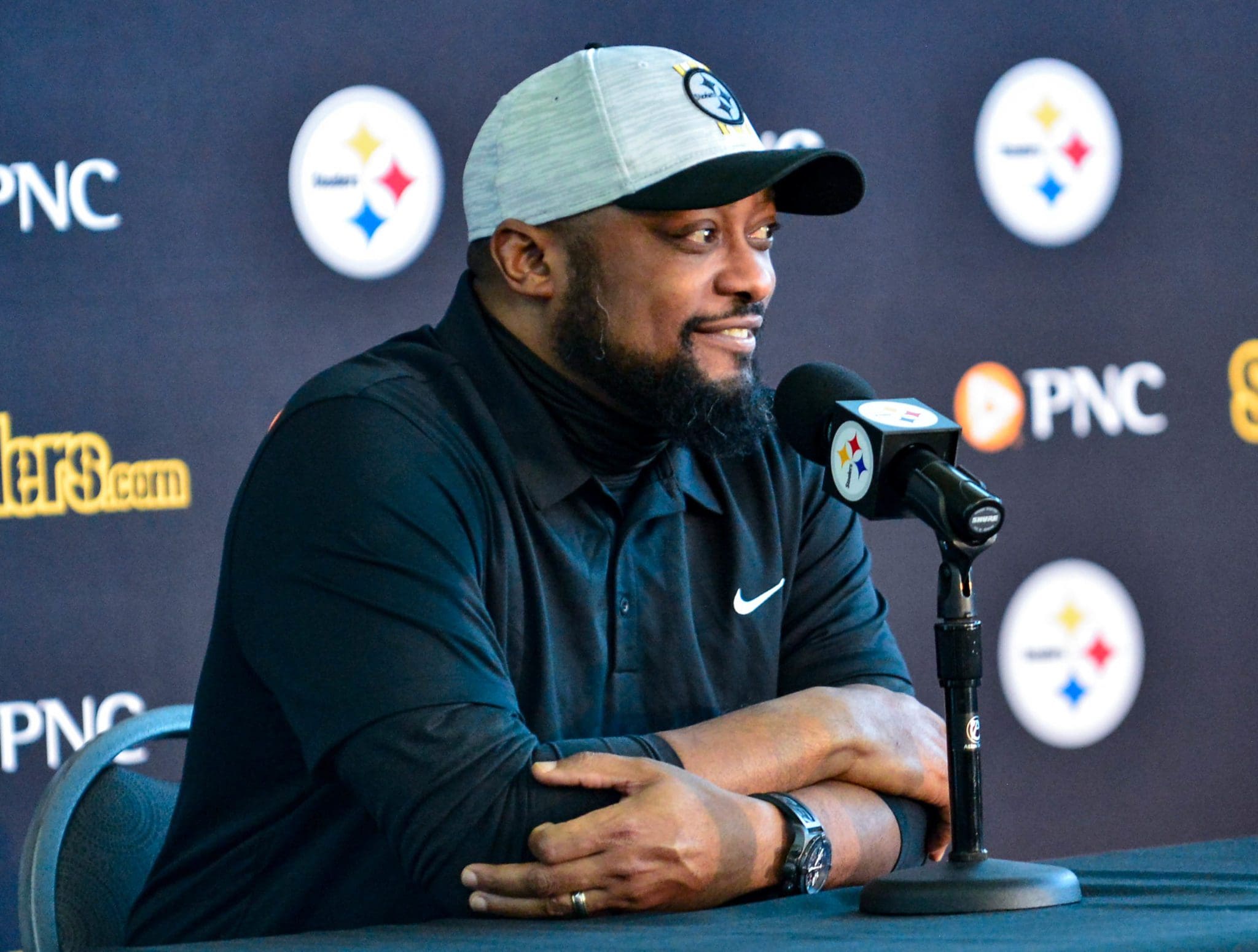 Mike Tomlin wearing a black jacket and gray cap