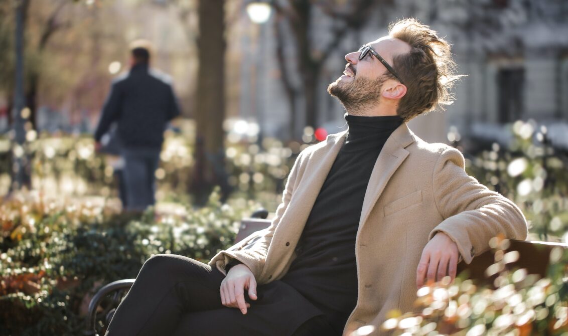Happy man in a bench