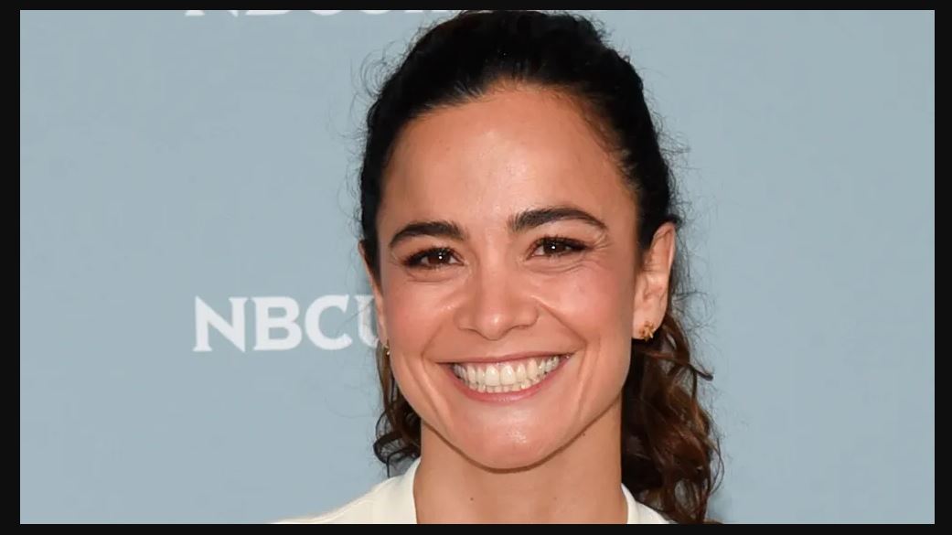 Alice Braga smiling as she attends an event