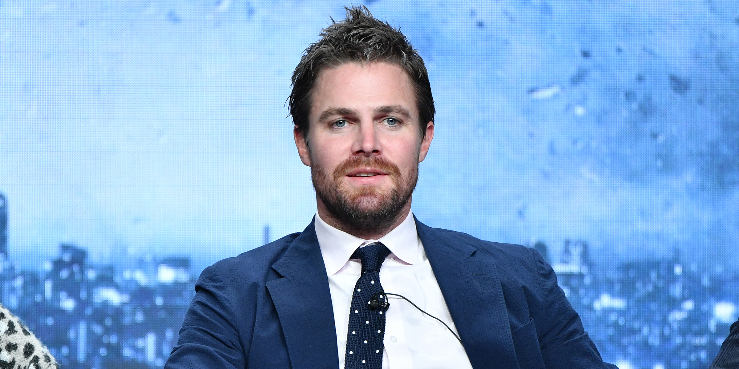 Stephen Amell wearing a blue suit